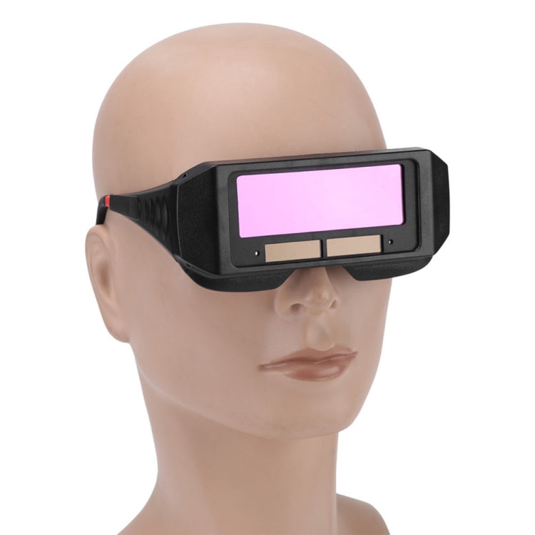 Auto-darkening welding helmet eyes protector worn on face with purple filter visor