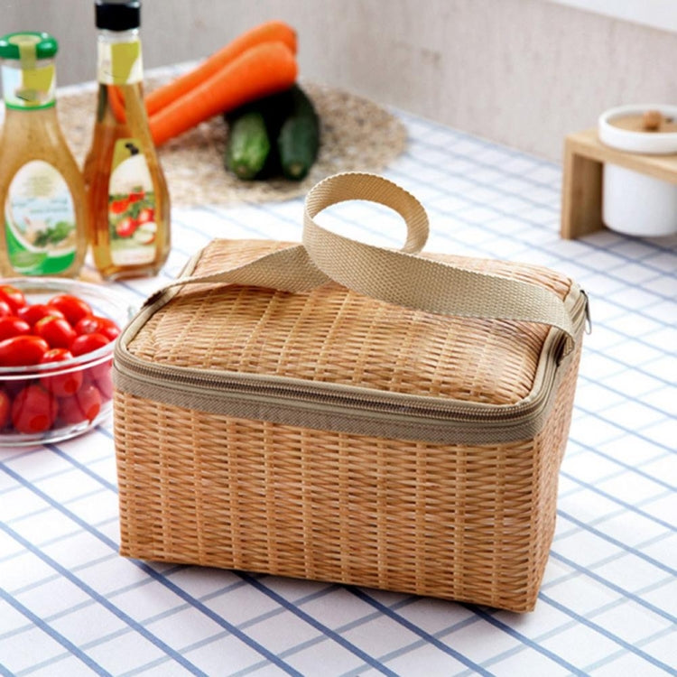 Thermal wicker picnic bag with zip top and carry handle beside vegetables and bottles