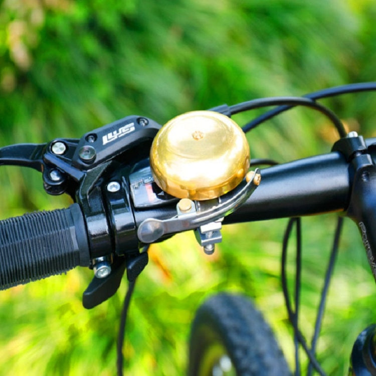 Golden bicycle brass bell with dome top and handlebar clamp attachment
