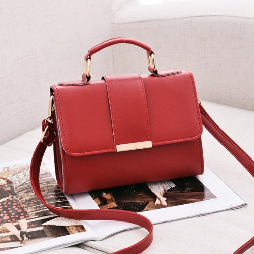 Red small flap crossbody handbag with top handle and adjustable shoulder strap