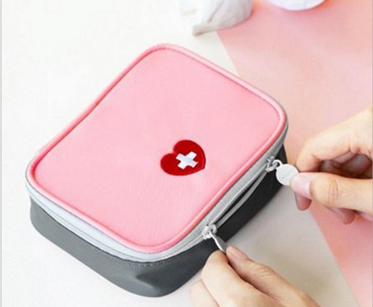 Pink mini first aid medicine bag with red heart-plus emblem and zipper pull