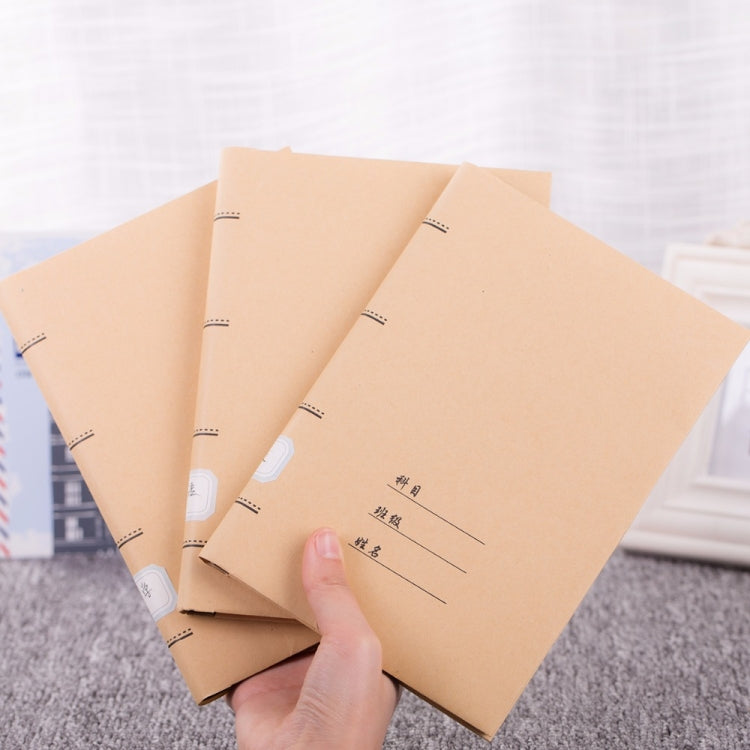 Kraft paper book cover stack with dashed borders and guideline lines, held by hand