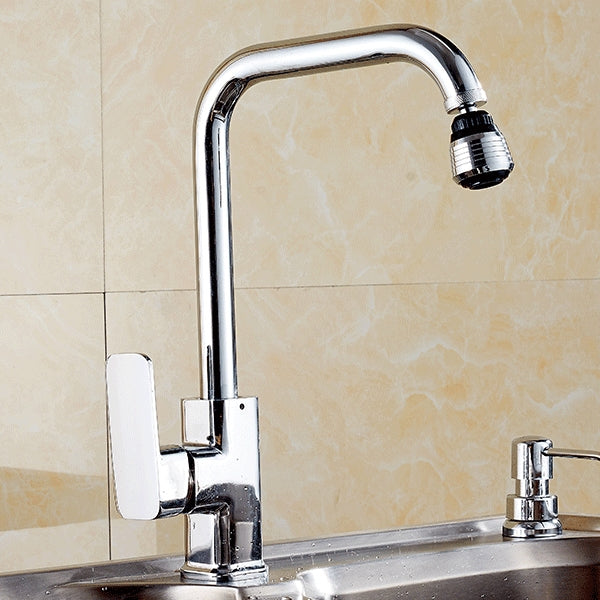 Water filter tap adapter mounted on a kitchen sink faucet, shiny chrome finish.