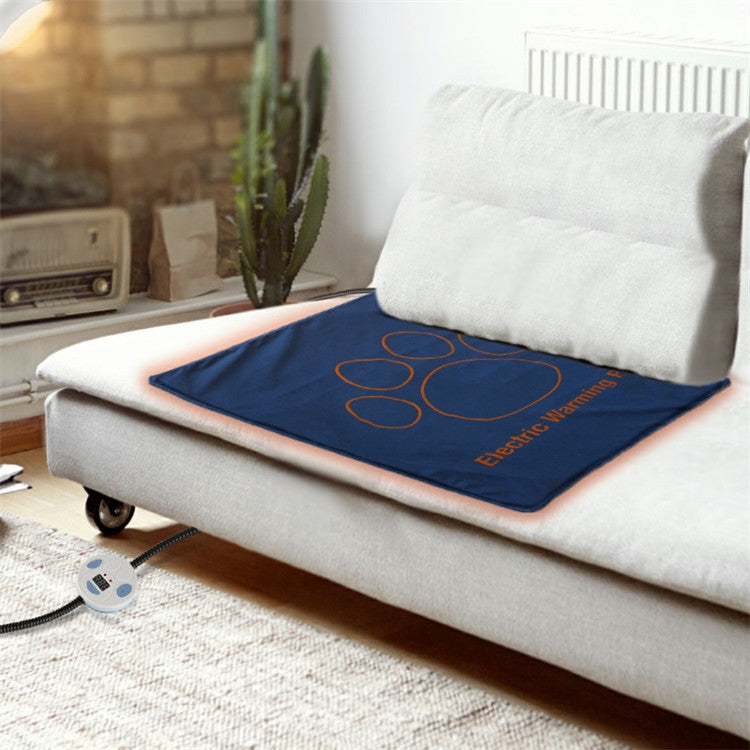 Electric pet heating pad on couch, navy blanket with red line pattern