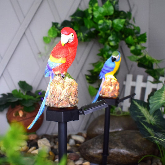 Two resin parrot solar lawn lamps, red and blue birds, glowing light on black stakes