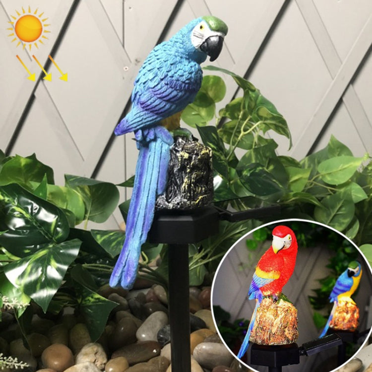 Blue and green resin parrot solar lawn lamp on a black stake base among plants