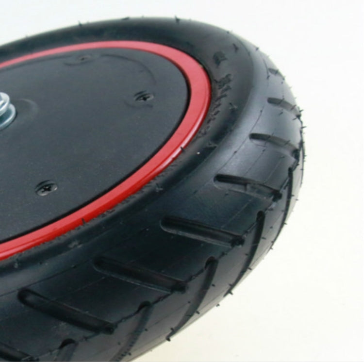 Electric scooter drive wheel tire with black tread and red rim edge