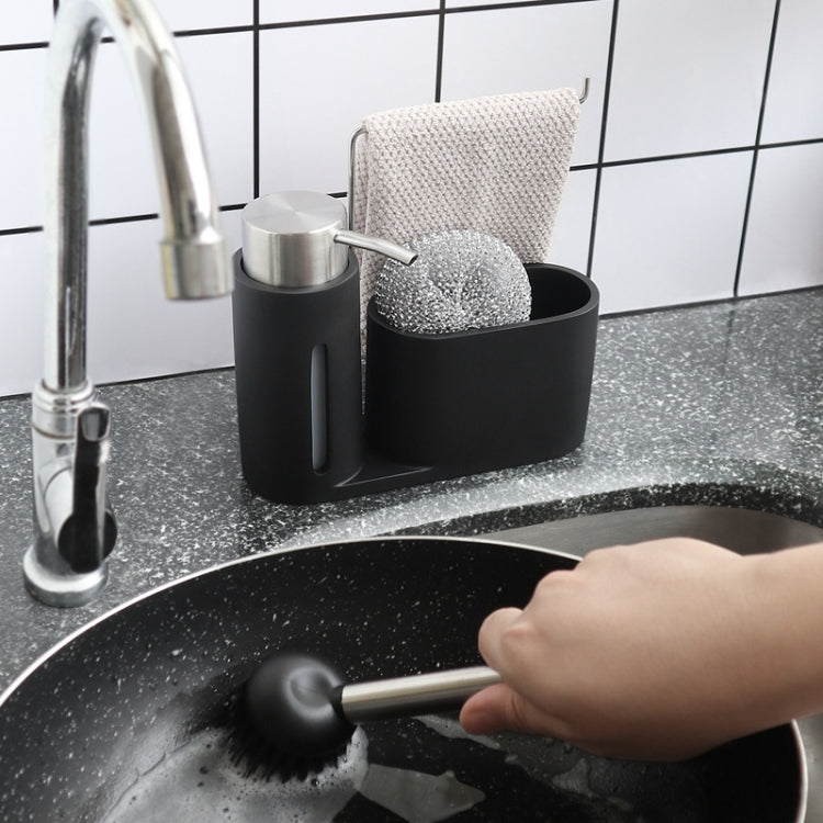 Black kitchen sink brush set with soap dispenser, scrub pad and brush near cookware