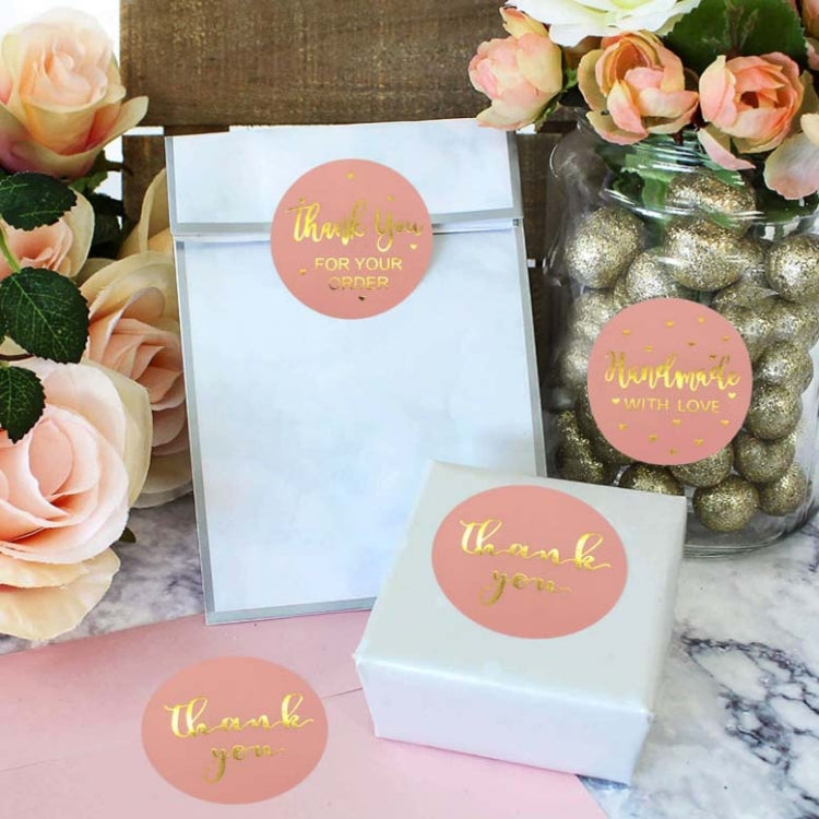 Pink circular thank-you stickers on gift boxes; gold foil self-adhesive labels
