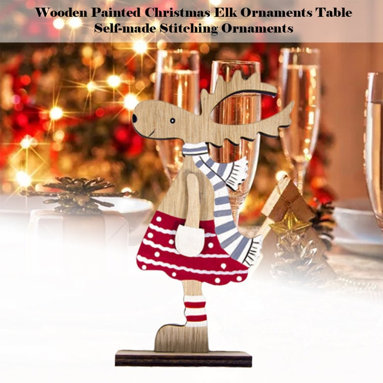 Wooden painted elk ornament on base, red striped cap and scarf with red dotted dress