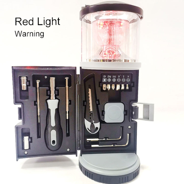 Black camping lantern showing red warning light with open hardware tool tray