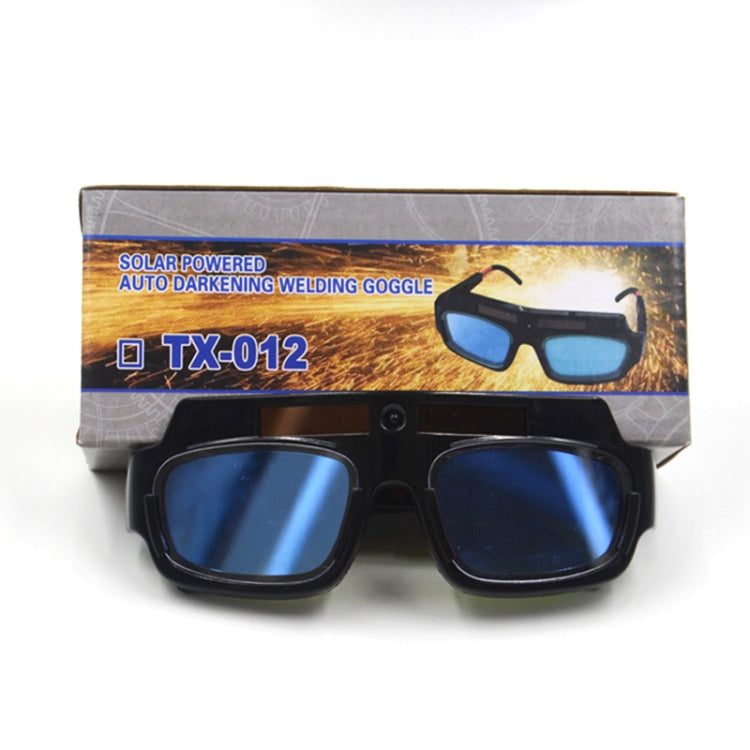 Auto-darkening welding goggles in packaging, black frame with blue tinted lenses