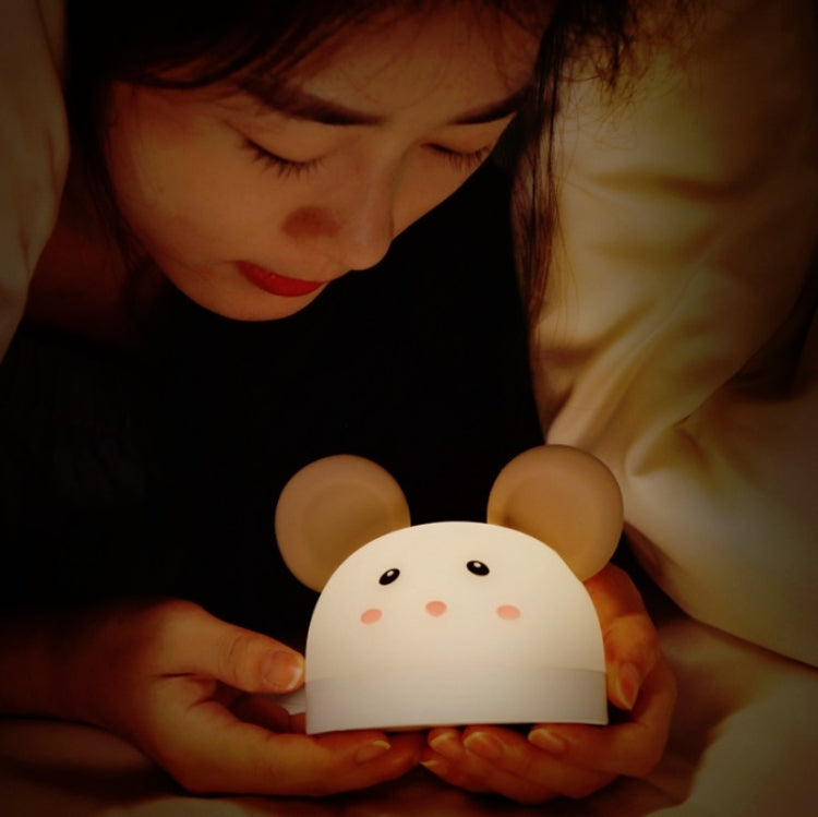 Mouse night light held in hands, warm glow with friendly face details