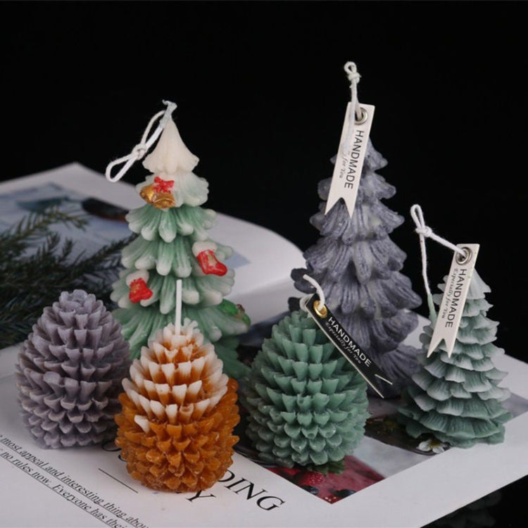 Assorted Christmas tree scented candles in gray, green, orange, and cream with tags
