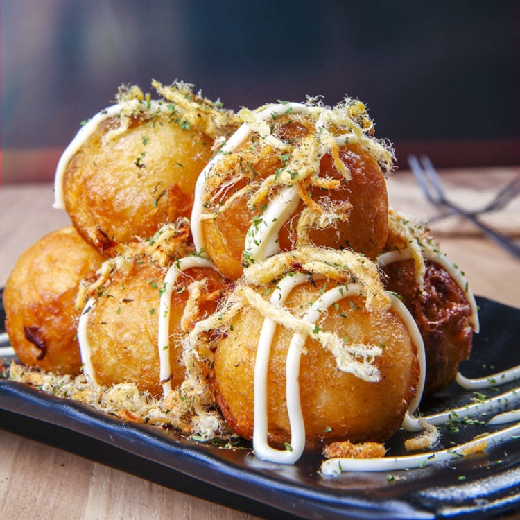 Takoyaki-style octopus balls with creamy sauce drizzle and shredded toppings