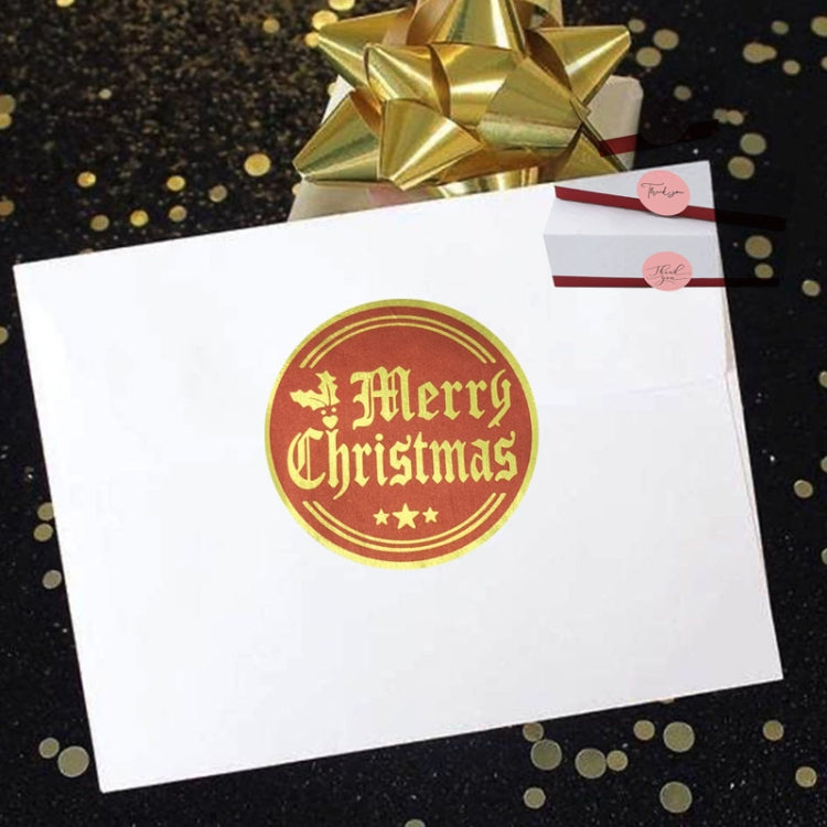 Christmas sticker label on card featuring a gold “Merry Christmas” round design