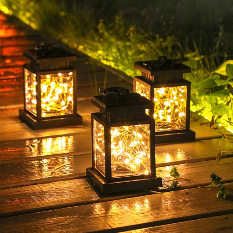 Set of solar lantern lights with warm glow, black square frames, clear glass and filaments