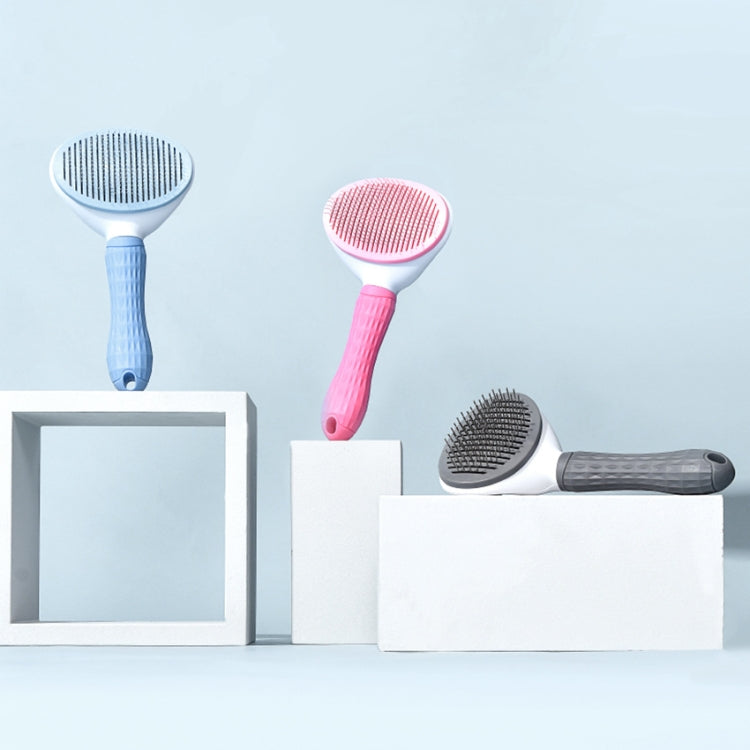 Pet hair removal brushes in blue, pink, and gray on display stands