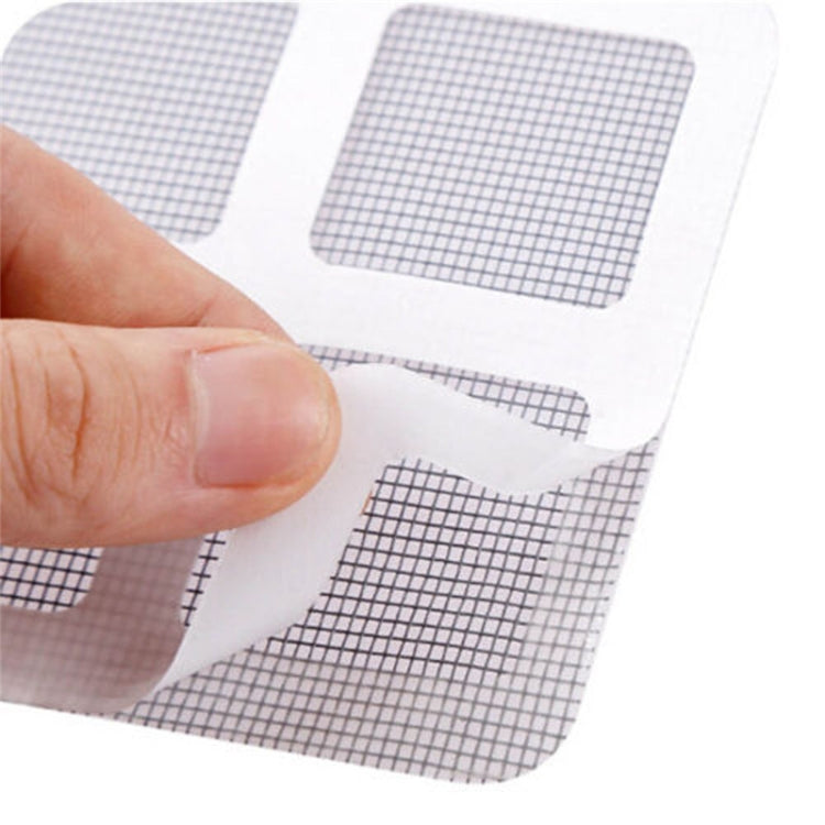 Adhesive mesh patch with backing being peeled by fingers