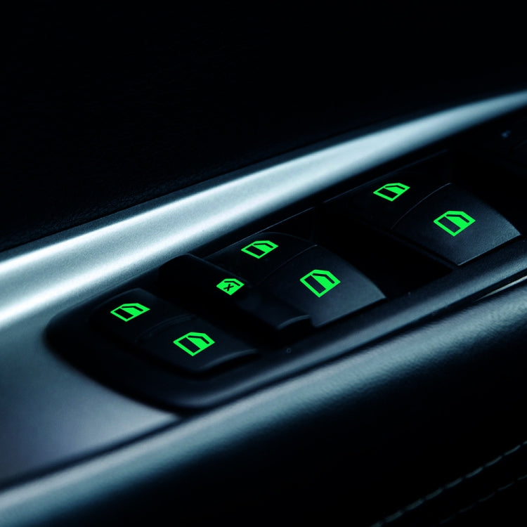 Car window switch sticker with green glowing icon symbols on door control panel