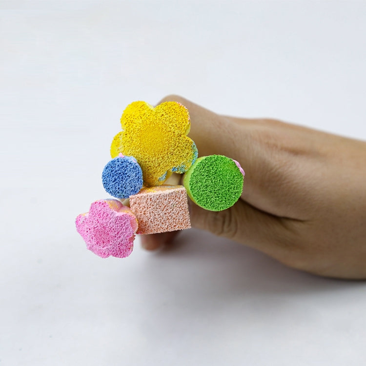 Hand holding assorted mushroom sponge stamps on wooden handles: green yellow blue pink orange