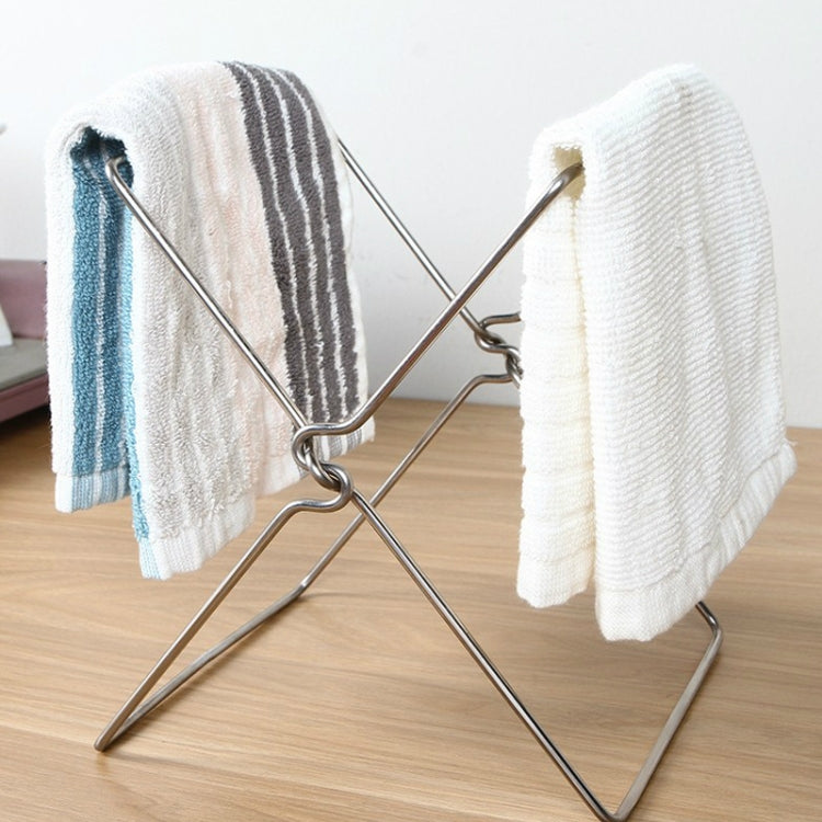 Foldable stainless steel towel rack with four grips, holding two folded kitchen towels