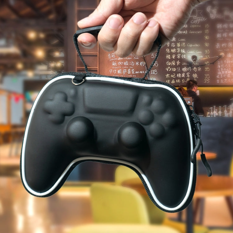 Black controller-shaped hard case storage bag held in hand with zipper closure