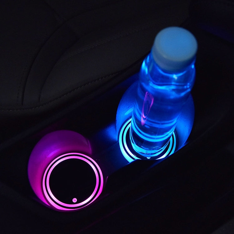 Pair of glowing round LED coasters with blue and purple light rings