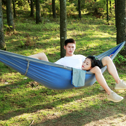 Blue double outdoor hammock with mosquito net, hanging swing-style camping bed