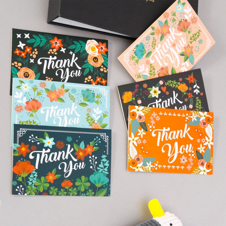 Top view of six floral Christmas thank-you greeting cards, each with “Thank You” in script