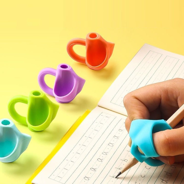 Silicone three-finger pen grip in teal, writing with pencil; orange and purple grips nearby