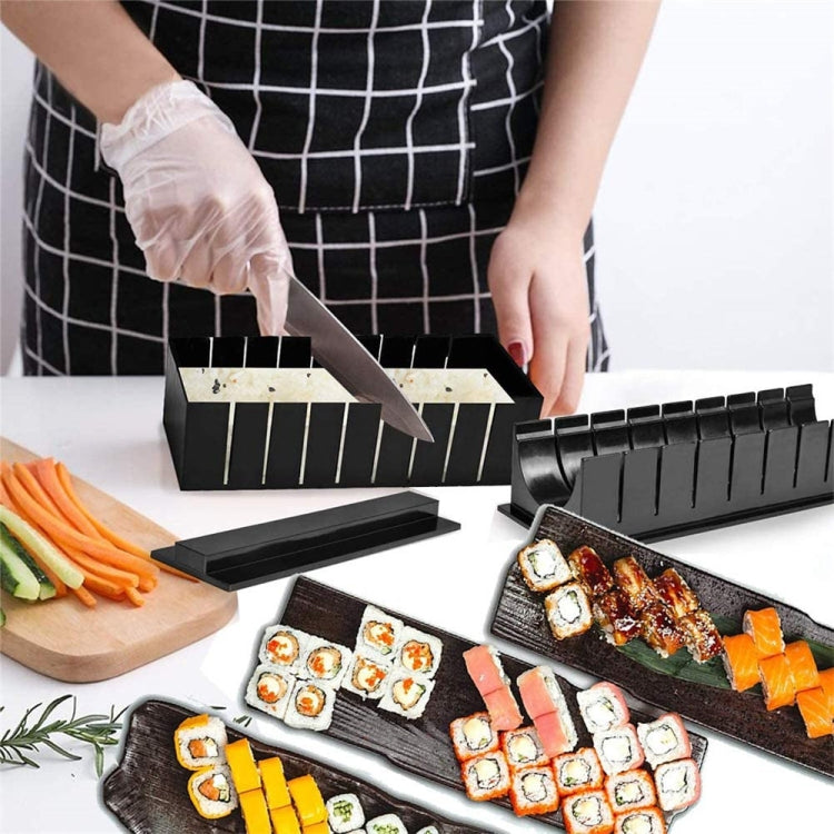 Black sushi molds in use with gloves and rolling frames during sushi making