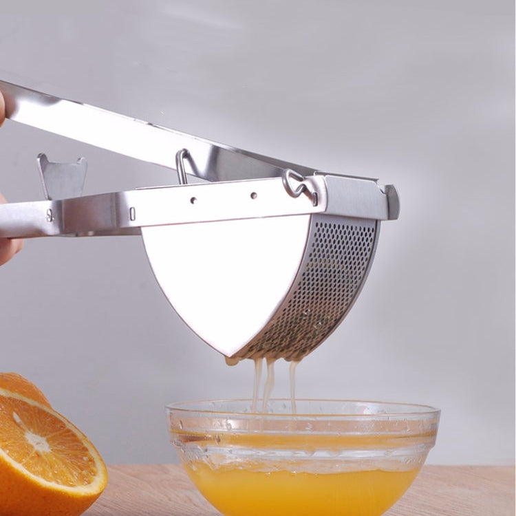 Stainless steel manual juicer press held above bowl with citrus halves