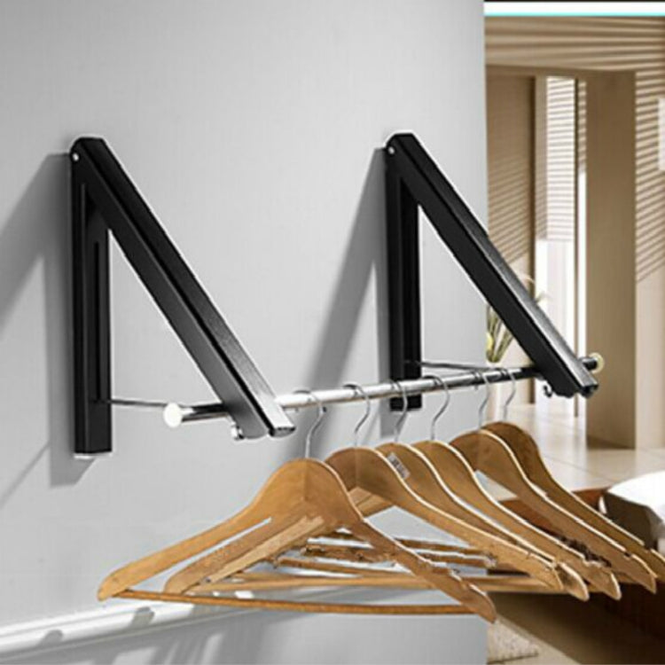 Black wall-mounted drying rack with hooks holding wooden hangers