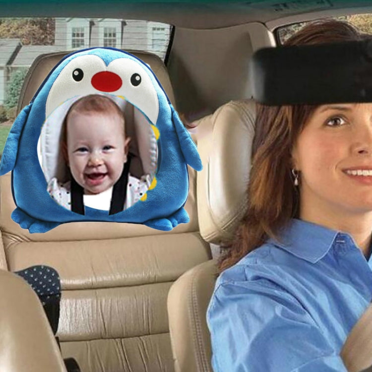 Penguin plush rearview mirror pendant with blue hood framing baby in car seat