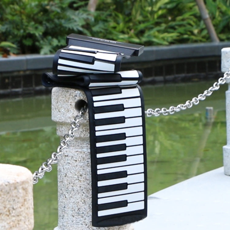 Rolled foldable MIDI keyboard on a chain, black with white keys