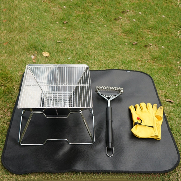 Black camping fireproof silicone cloth pad laid flat with grill tools