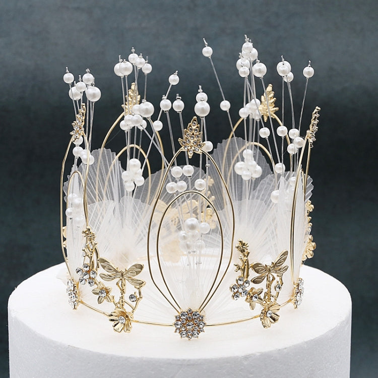 Ornate gold-tone crown cake topper with pearl beads and butterfly charms, full view