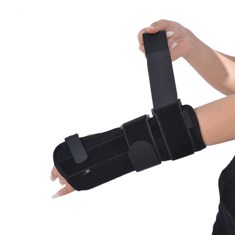 Black wrist splint with adjustable strap and padded wrist pad, size M, on hand