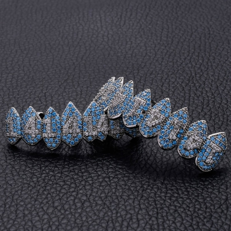 Blue and silver rhinestone teeth grill braces on black leather-look surface