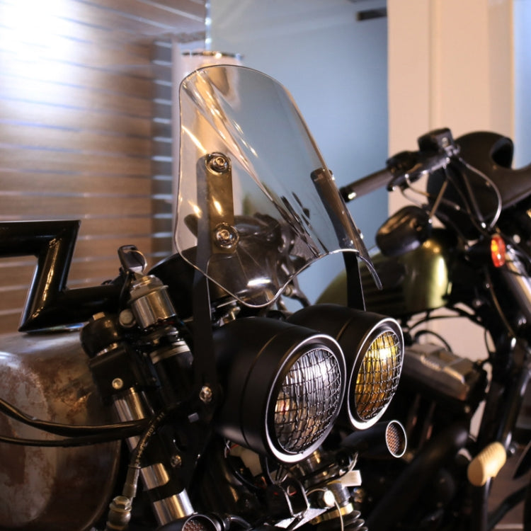 Dual retro headlights with clear and amber lenses in black housings, mounted on bike.
