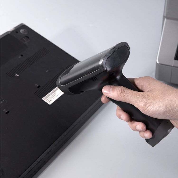 Black handheld barcode scanner gun held in hand with dark scanning window