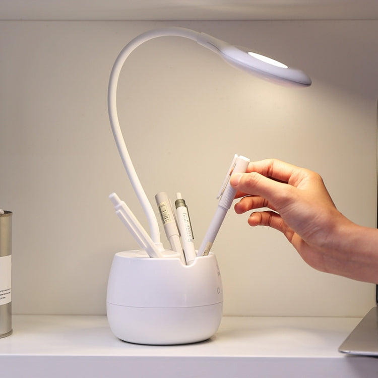 White desk lamp with adjustable ring head; hand adjusting the neck