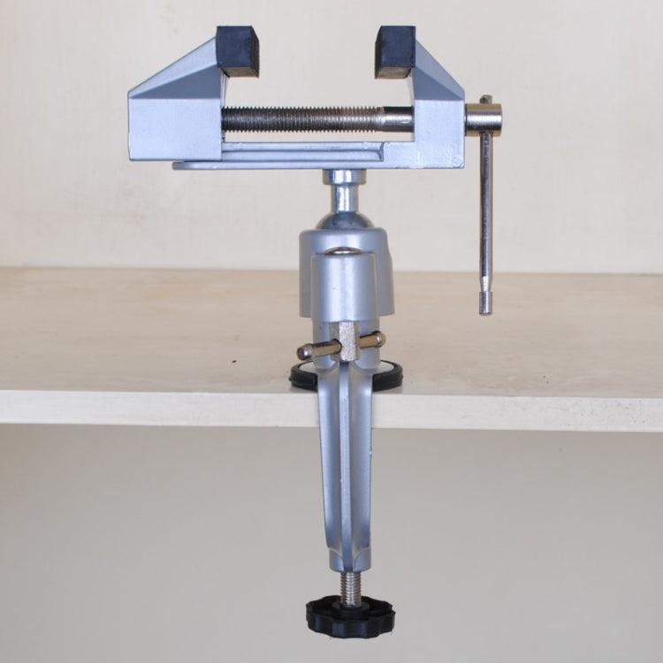 Small bench vise front view with fixed jaw and lever handle, light gray metal