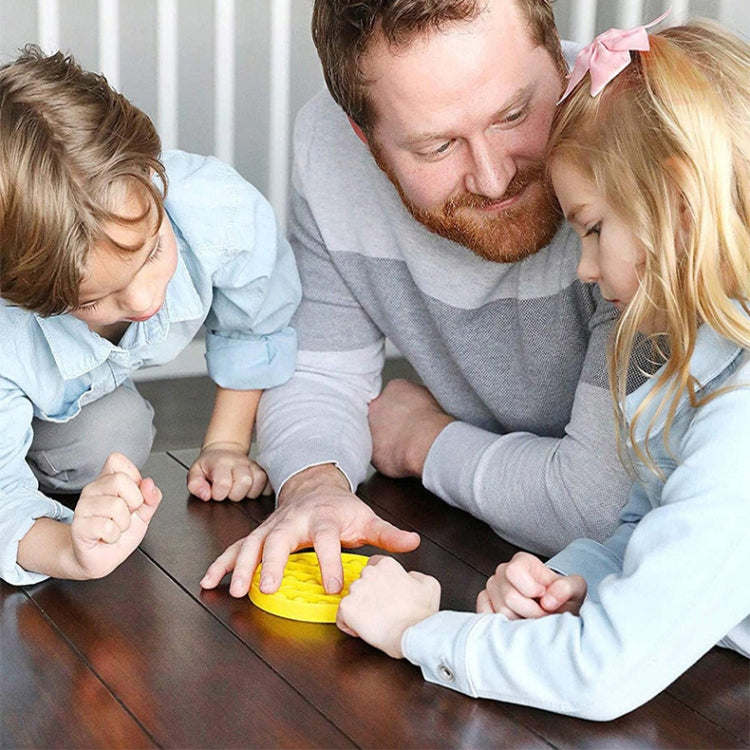 Yellow round silicone press board with bubble buttons, played by family at table