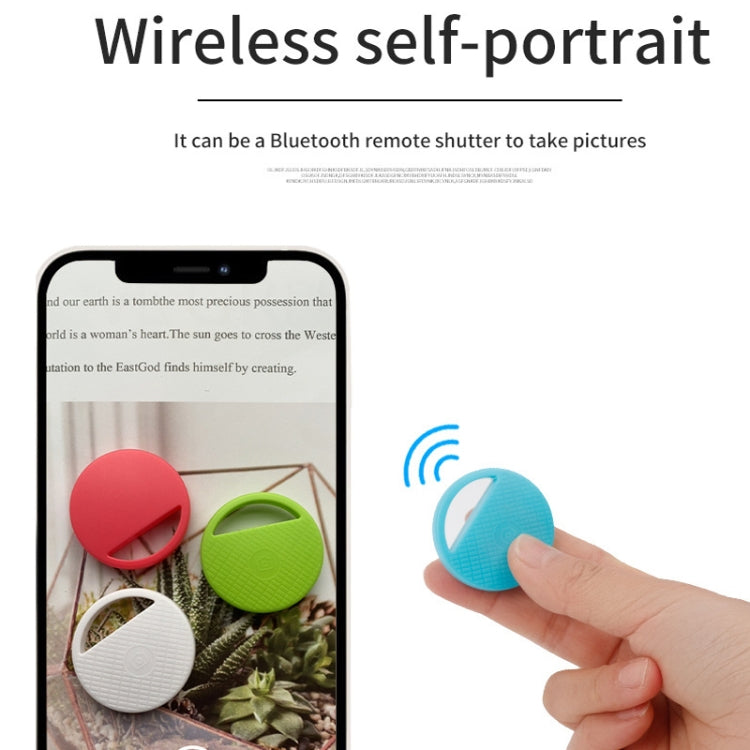 Round Bluetooth item finder tag used as wireless selfie remote, held in hand