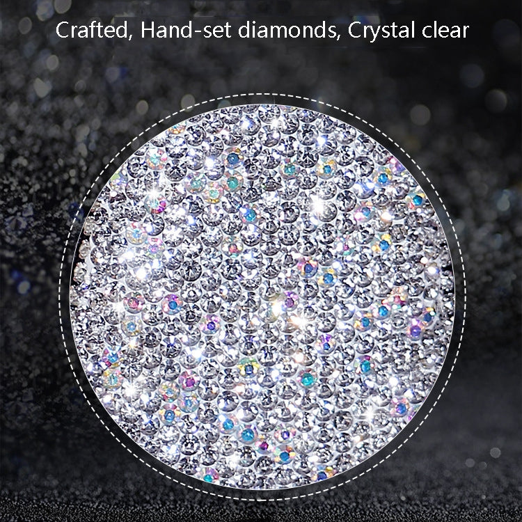 Close-up rhinestone surface on white glitter key case with black border
