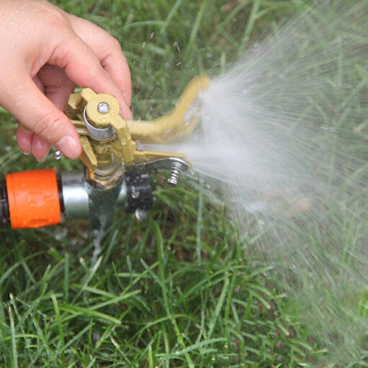 Rotating lawn sprinkler releasing water mist from the copper spout
