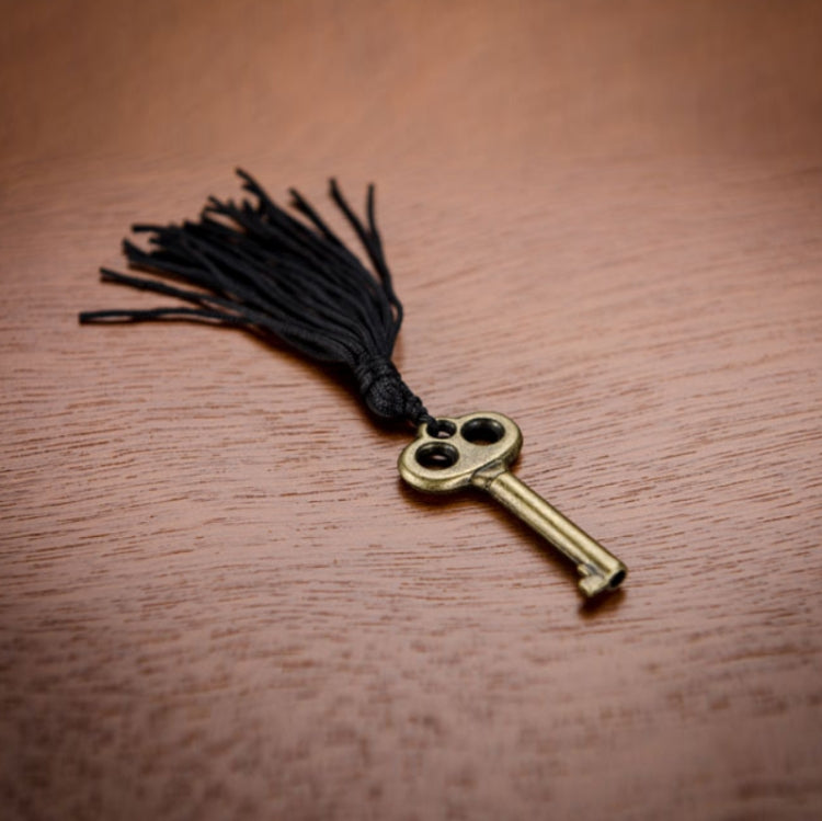 Brass key with black tassel for wooden watch storage box lock