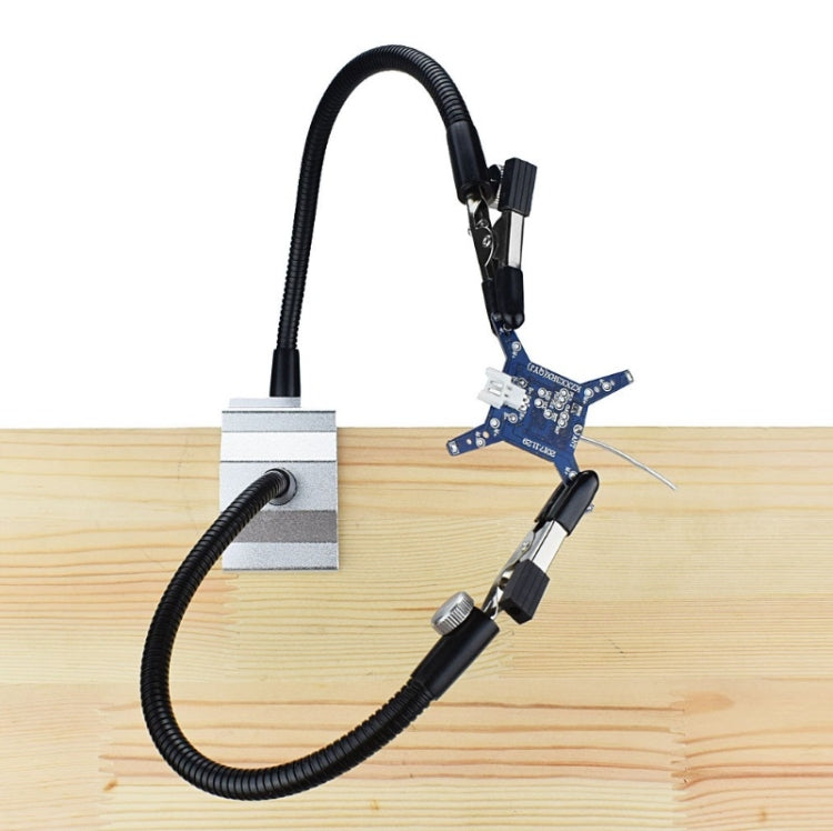 Two-jaw soldering iron holder bracket mounted to wood with coiled cable and iron